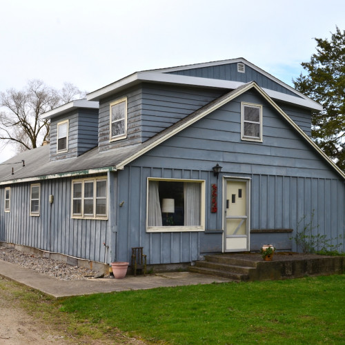 3 bedroom home w/ an oversized 2-car detached garage, (3) outbuildings and empty lots on Bear Lake